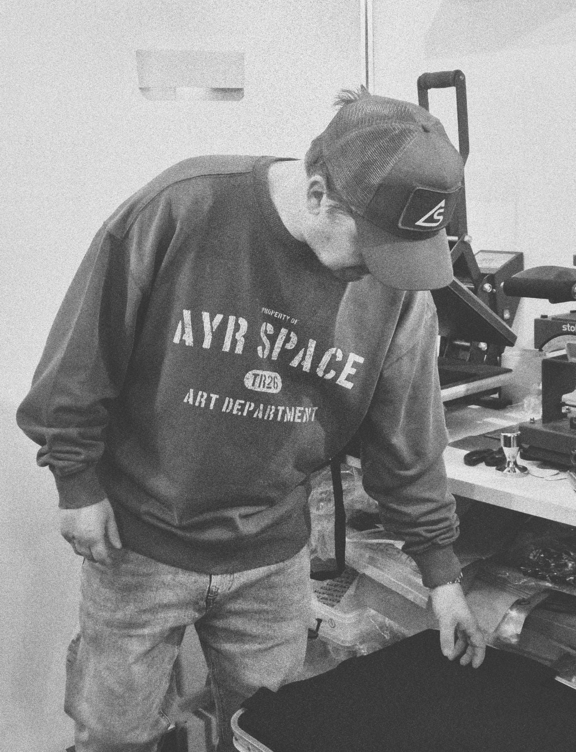Dan, founder of Ayr Space, printing at the heat press in the Fore Street studio, St Ives