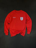 Front of the Sea Lions Long Sleeve in Away Red, laid flat: retro-style crest with three sea lions on the chest and a small white text print opposite
