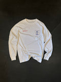 Front of the Sea Lions Long Sleeve in Home White, laid flat: retro-style crest with three sea lions on the chest and a small red text print opposite