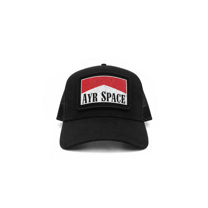A black trucker hat with a front patch featuring a red and white design and the text 'AYR SPACE' in black, shown against a plain white background.