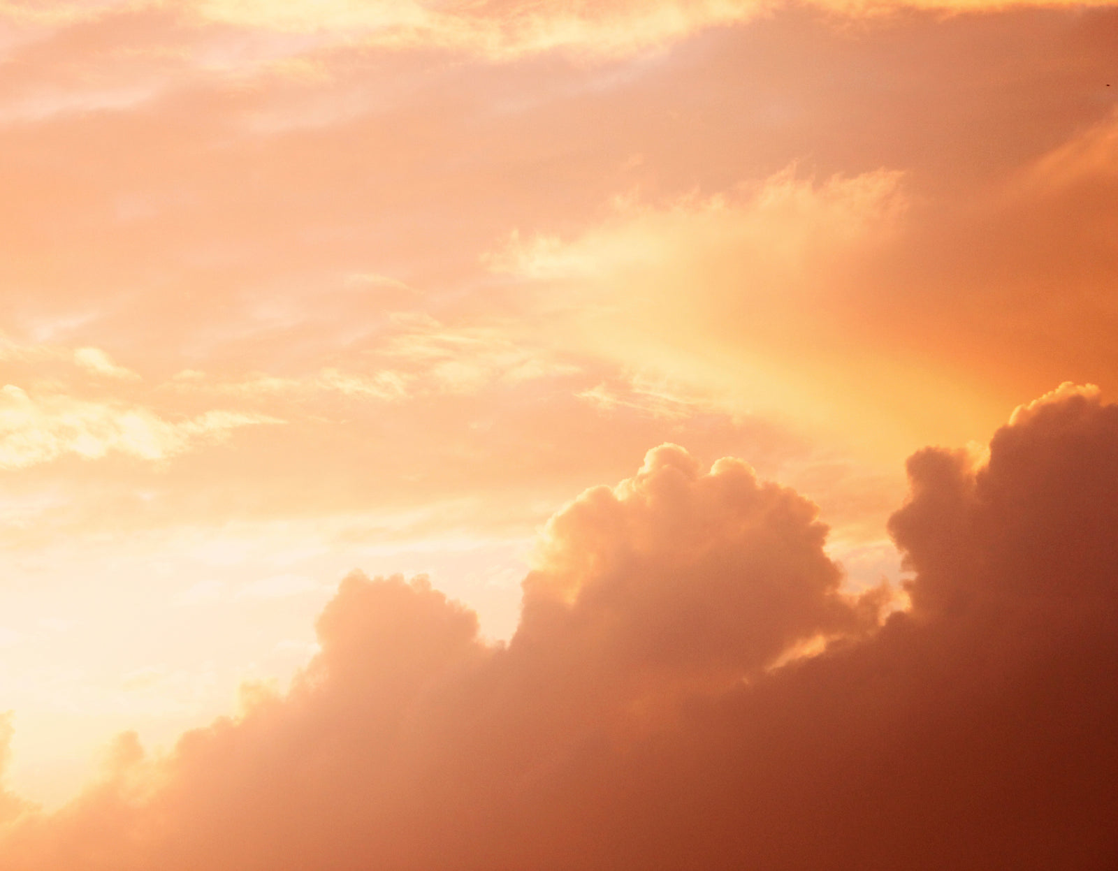 Warm peach and orange sunset clouds over St Ives
